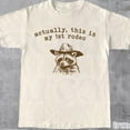 thumbnail image 1 of DOPASHIRT Actually, This Is My First Rodeo T-Shirt | Funny Western Graphic Tee | Animal Quote | Retro Shirt Unique Gift Idea | Unisex Shirt Unisex S-5XL Hot Trending Shirt, Vintage Birthday Gift, 1 of 4