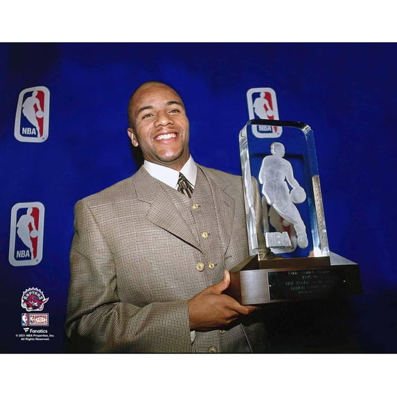 Damon Stoudamire Toronto Raptors Unsigned Holding 1995-96 NBA Rookie of the Year Trophy Photograph