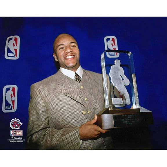 Damon Stoudamire Toronto Raptors Unsigned Holding 1995-96 NBA Rookie of the Year Trophy Photograph