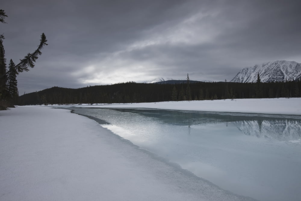 Dark Winter Evening On The Athabasca River In The Canadian Rockies Jasper National Park Alberta Canvas Art - Dan Jurak Design Pics (34 x 22)