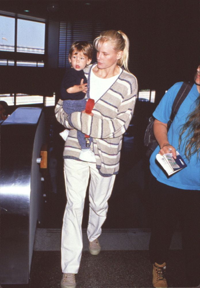 Daryl Hannah Holding Nephew In Lax Photo Print (8 x 10) Item