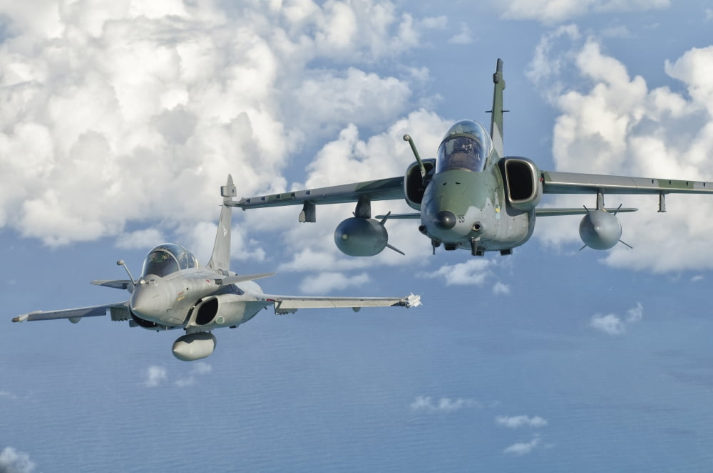 A Dassault Rafale of the French Air Force flys alongside an Embraer A-1B of the Brazilian Air Force Canvas Art - Giovanni CollaStocktrek Images (35 x 23)