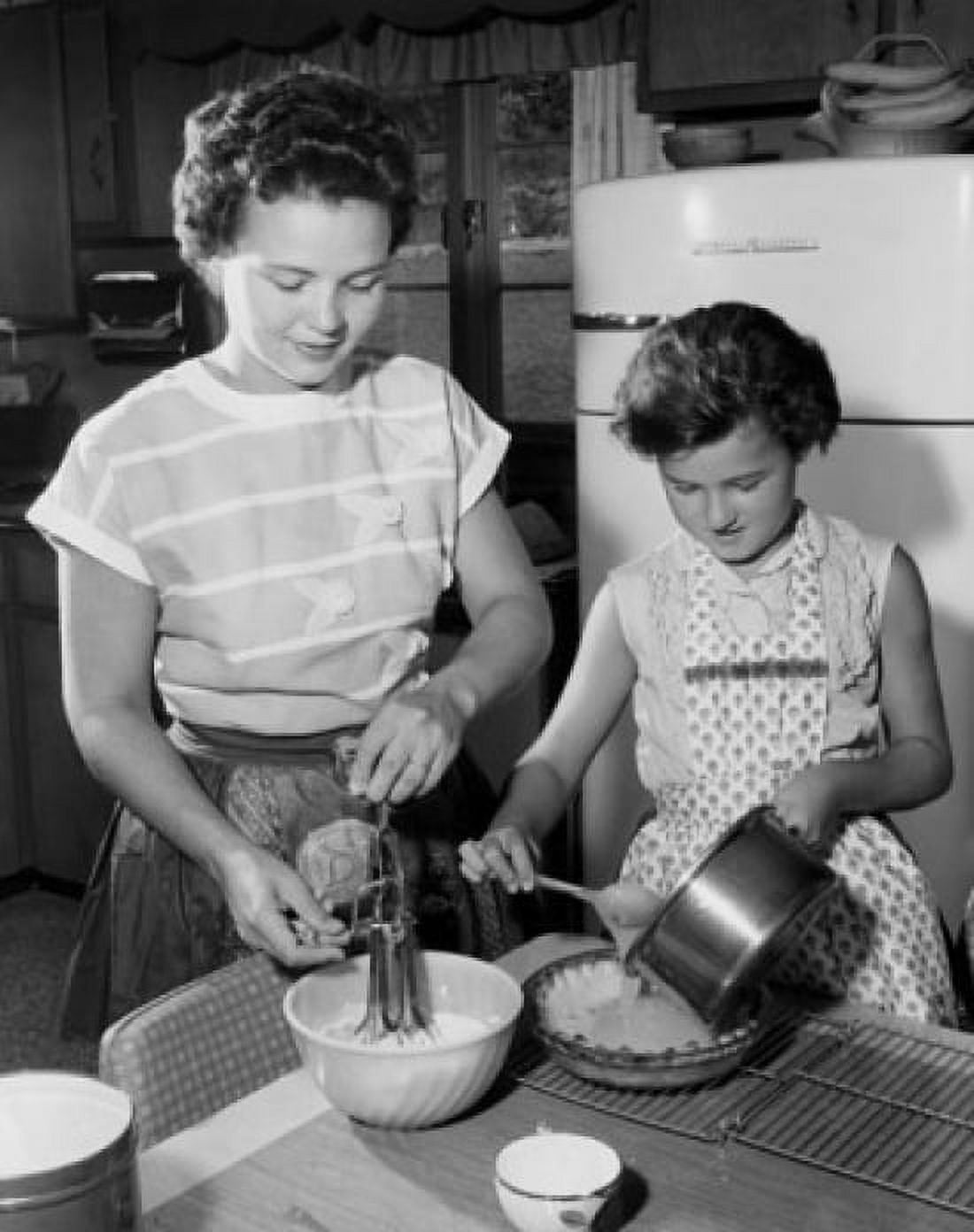 Daughter helping her mother in the kitchen Canvas Art - (18 x 24)