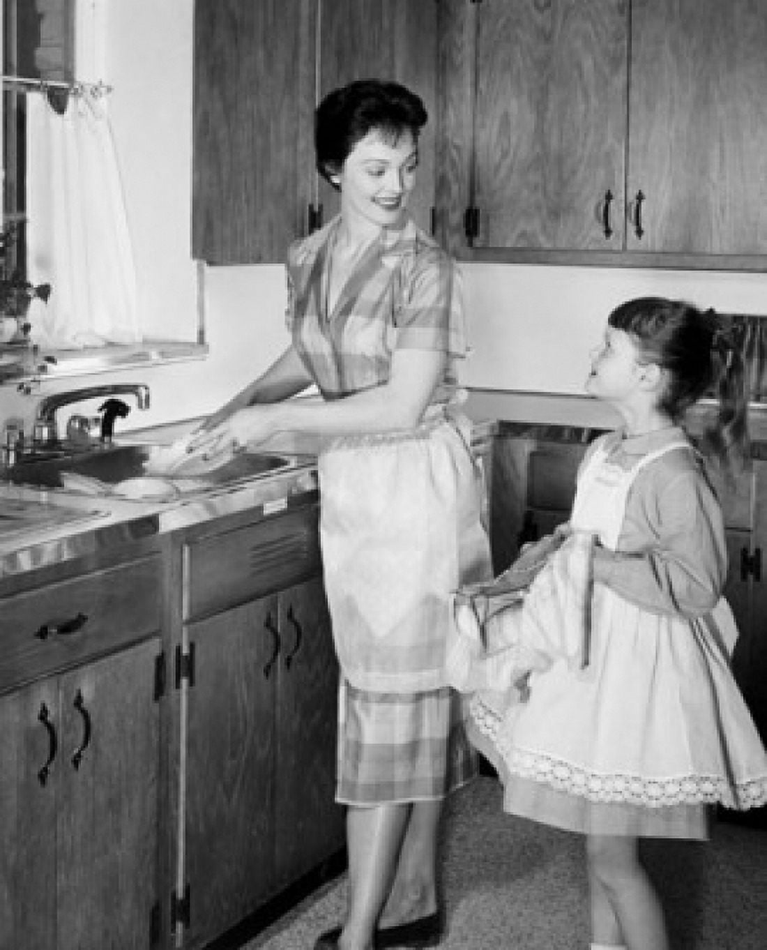 Daughter helping her mother wash dishes in kitchen Canvas Art - (24 x 36)