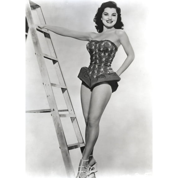 Debra Paget on a ladder Photo Print (8 x 10)