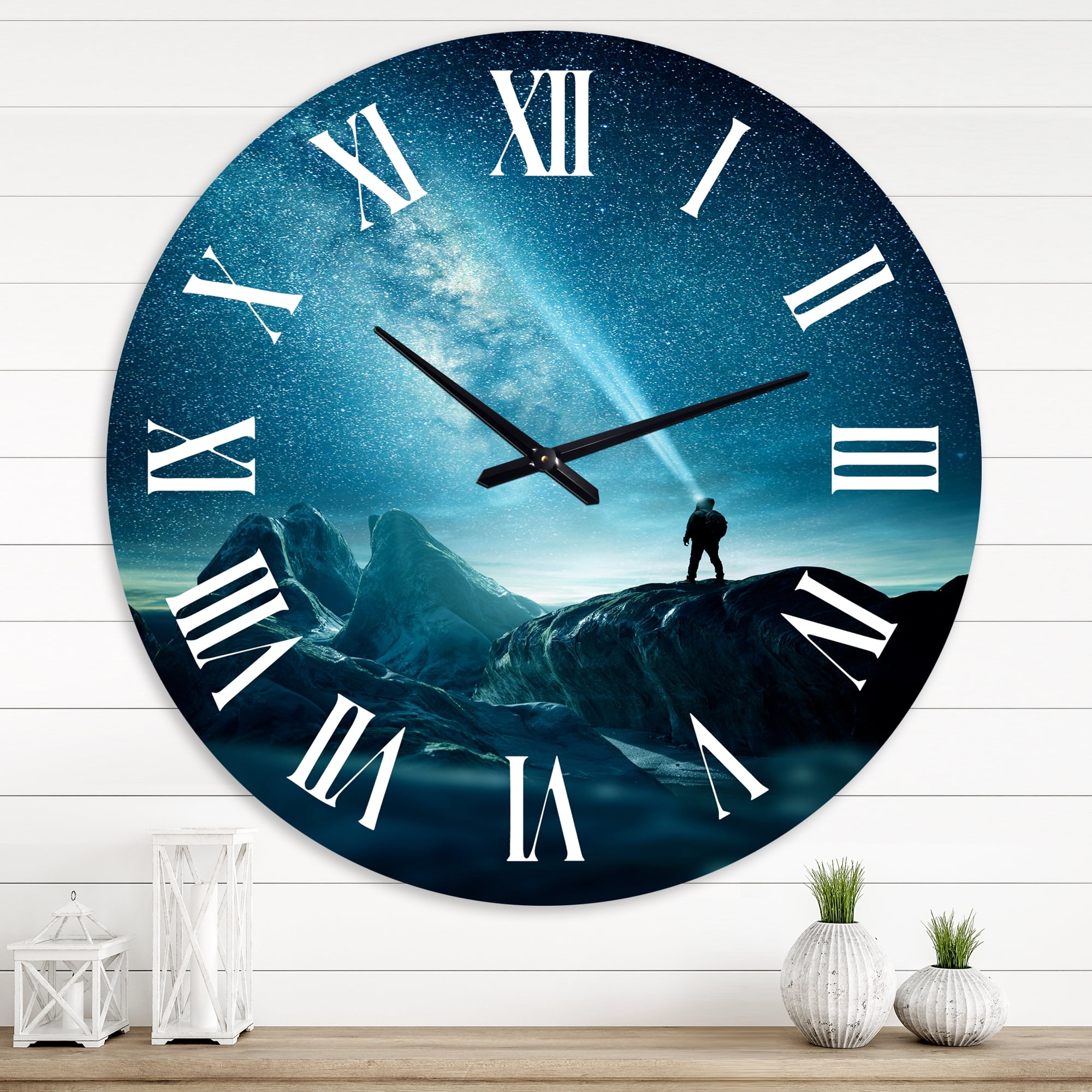 Designart 'A Man Shining A Light Into The Night Sky' Modern Wall Clock