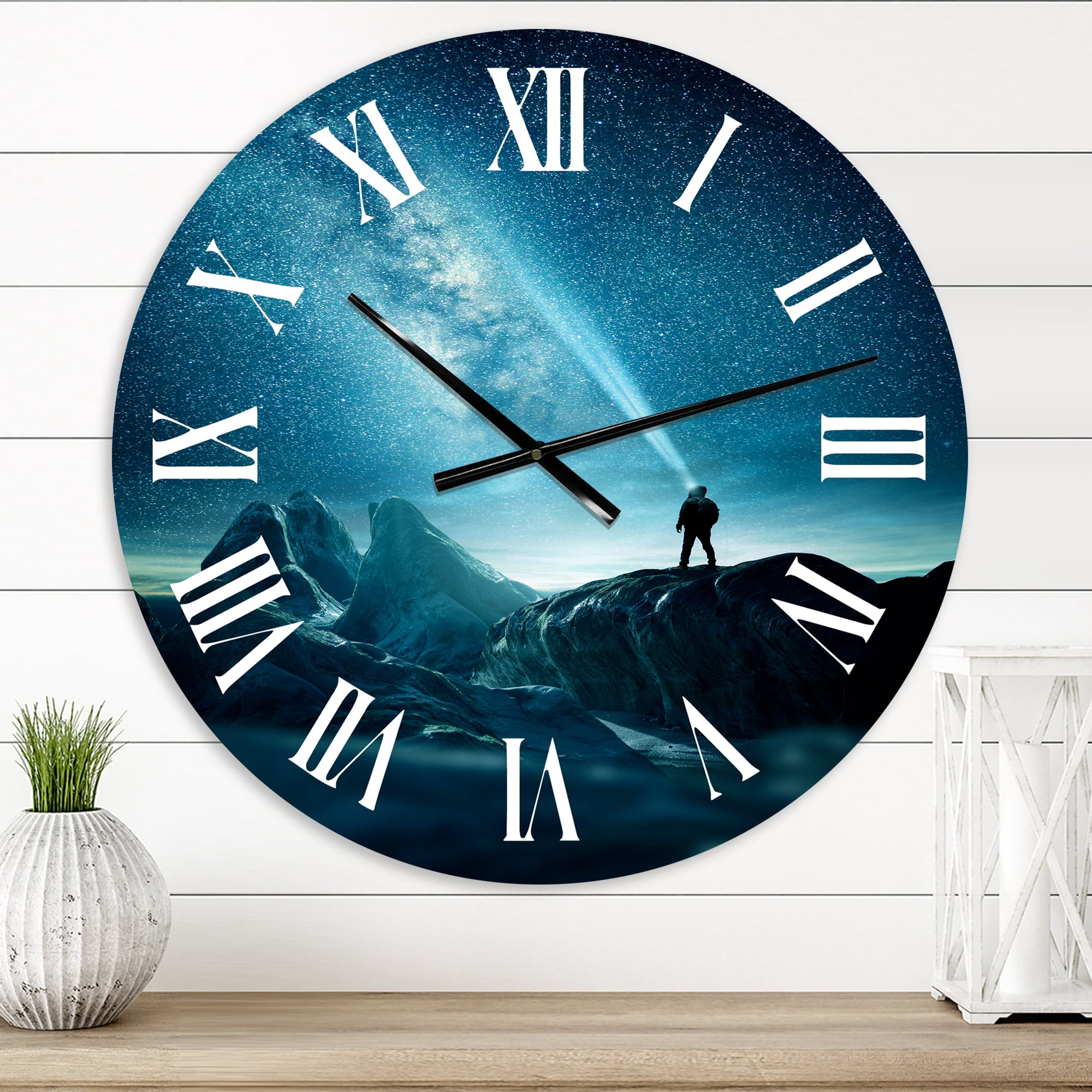 Designart 'A Man Shining A Light Into The Night Sky' Modern Wall Clock