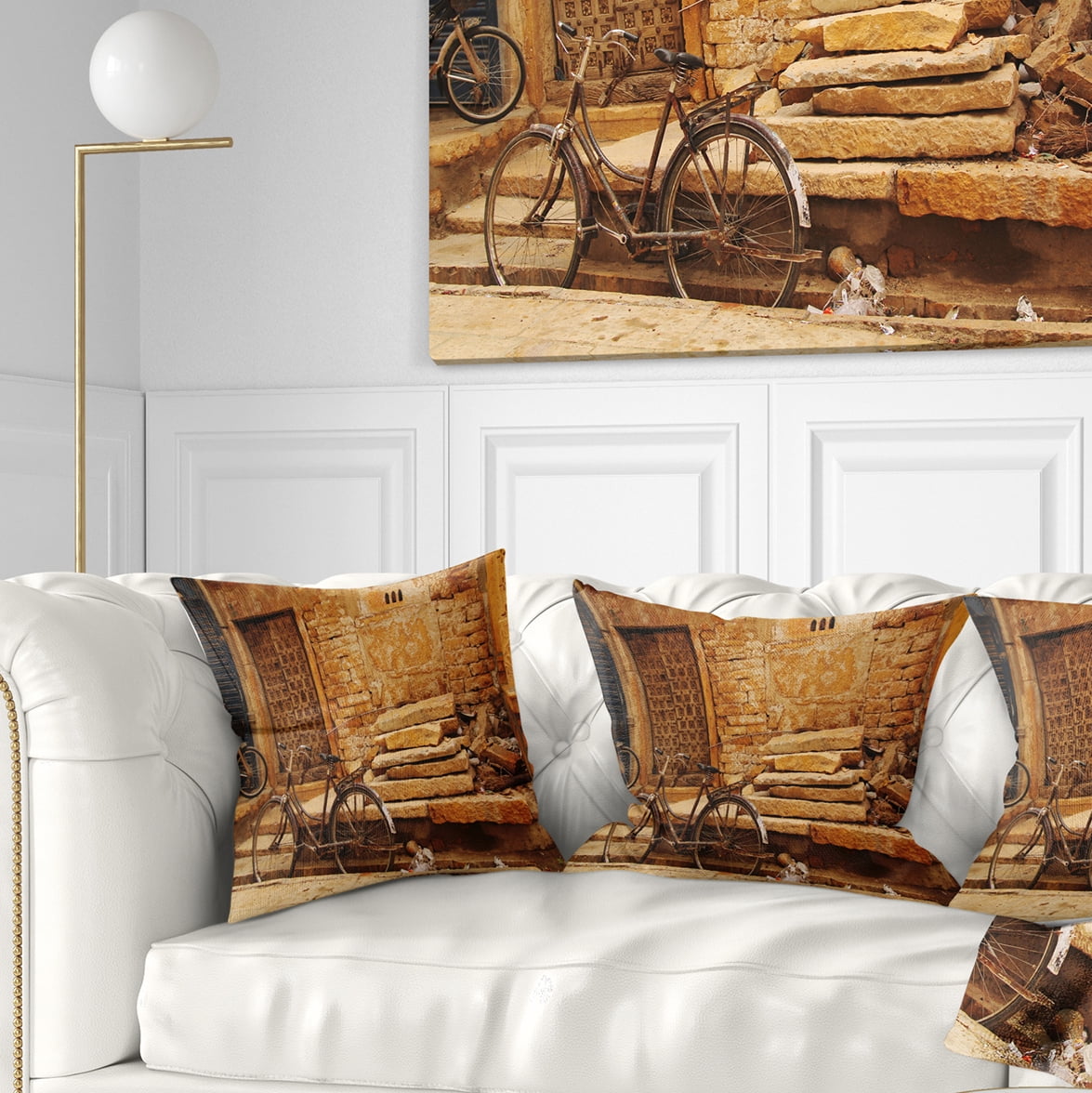 Designart Bicycle against Brown Wall - Landscape Photo Throw Pillow - 16x16