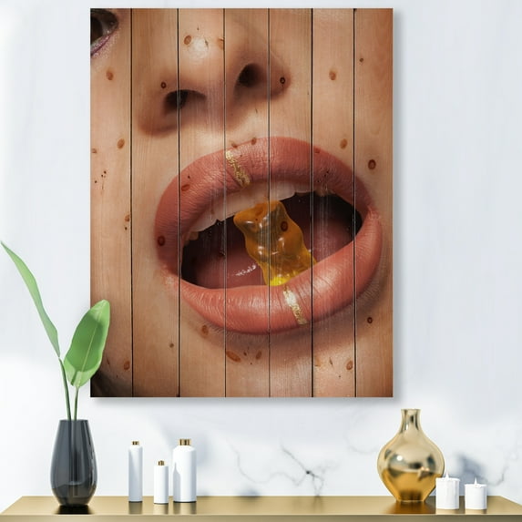 Designart 'Close Up VIew of Female Lips Biting Gummy Bear' Modern Print on Natural Pine Wood
