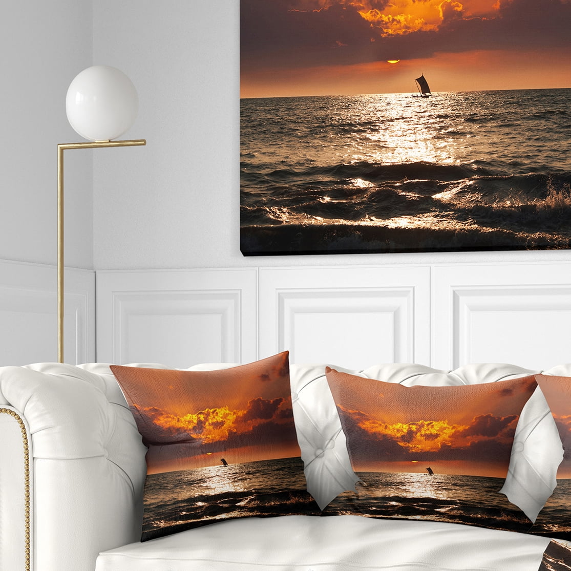 Designart Sunset Beach with Distant Sail Boat - Seashore Throw Pillow - 16x16
