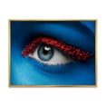 thumbnail image 1 of Designart 'Woman Eye With Blue Paint On Face & Red Balls' Modern Framed Canvas Wall Art Print, 1 of 5