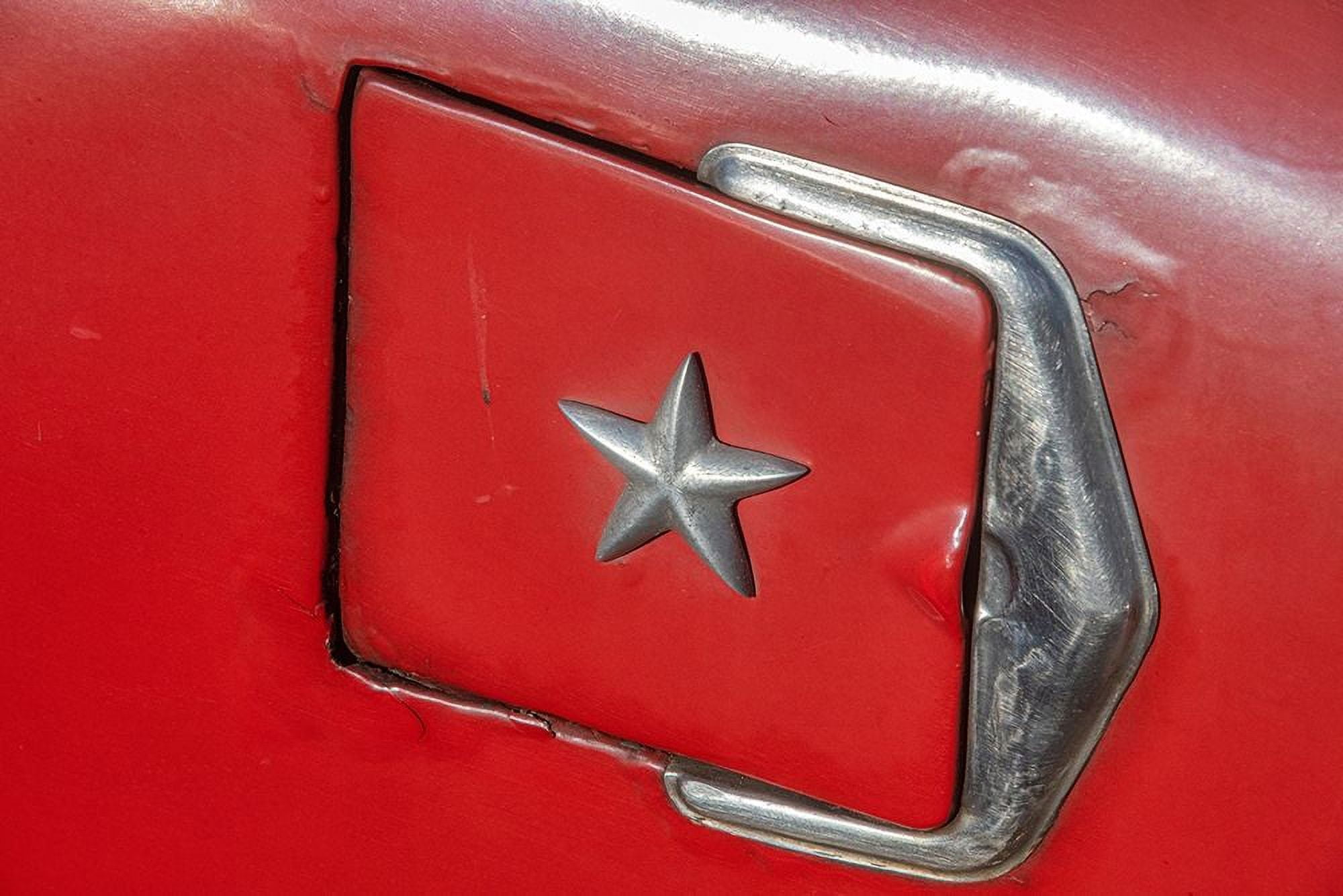 Detail of gasoline tank door with star on classic American car in Vieja