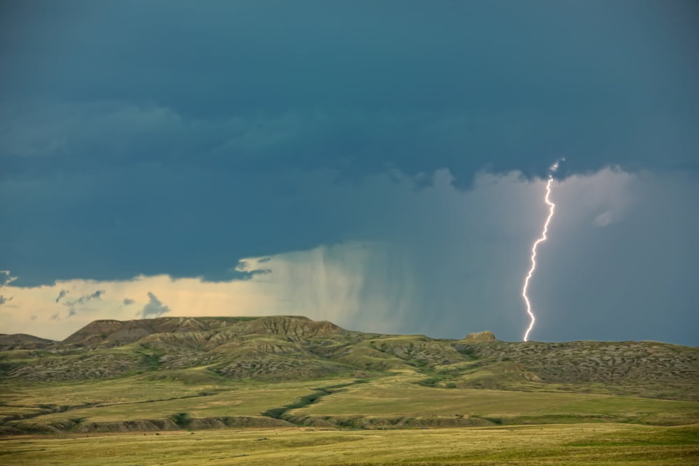 Digitally Enhanced Image With Painterly Effect Of Lightning Striking Over 70 Mile Butte And Sleeping Lion Butte Grasslands National Park Saskatchewan Canvas Art - Robert Postma Design Pics (34 x 22)
