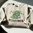 thumbnail image 1 of Dinosaur Pediatrics Nurse Embroidered Sweatshirt: PEDS Crewneck for Pediatric RN or Nurse Graduation, 1 of 4