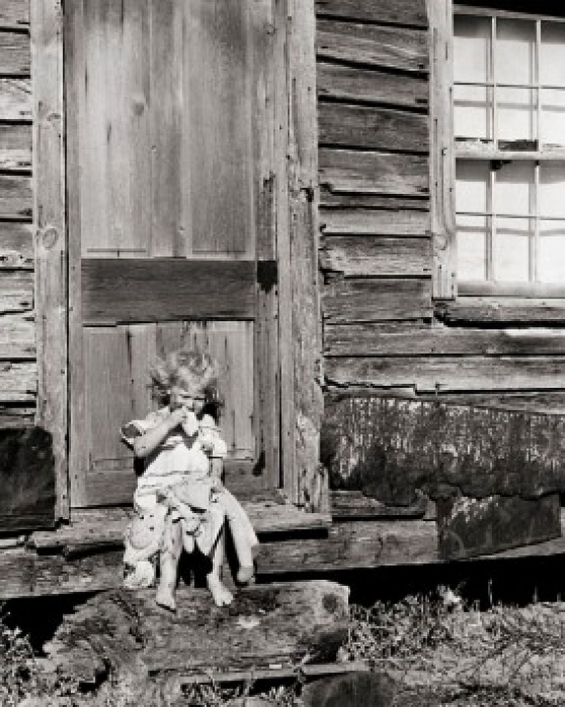 Dirty child eating food sitting on the doorstep of a house Canvas Art - (24 x 36)