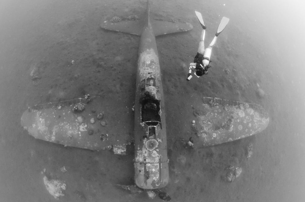Diver explores the wreck of a Mitsubishi Zero fighter plane Canvas Art - Steve JonesStocktrek Images (35 x 23)