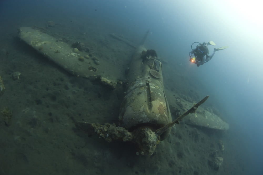 Diver explores the wreck of a Mitsubishi Zero fighter plane Canvas Art - Steve JonesStocktrek Images (35 x 23)