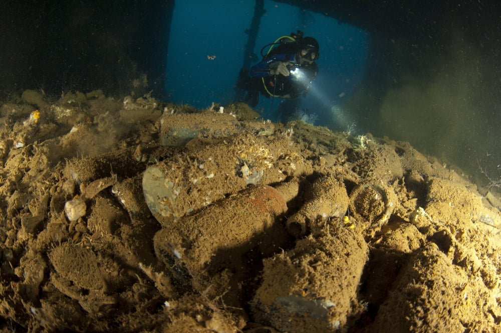 Diver exploring the WWII Japanese wreck of the Shinwa Maru Canvas Art - Steve JonesStocktrek Images (18 x 12)