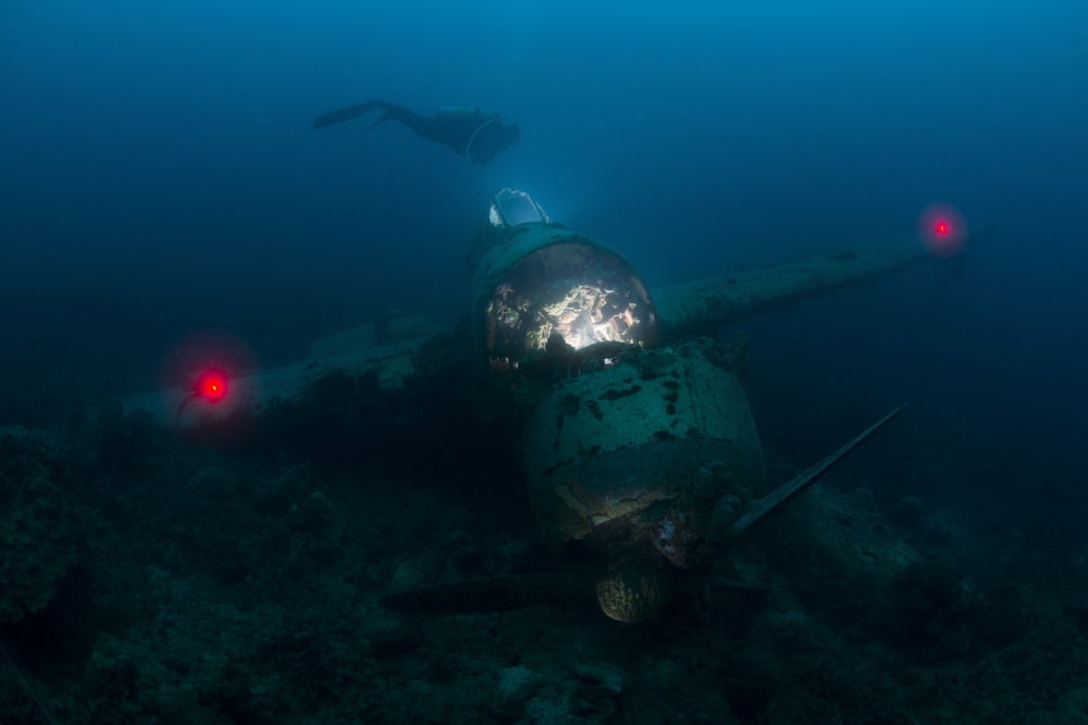 Diver exploring the wreck of a Japanese Navy Seaplane in Palau Micronesia Canvas Art - Mathieu MeurStocktrek Images (17 x 12)