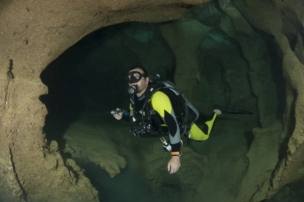 Diver exploring underwater cavern and caves Raja Ampat Indonesia Canvas Art - Steve JonesStocktrek Images (18 x 12)