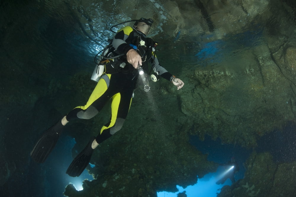 Diver exploring underwater cavern and caves Raja Ampat Indonesia Canvas Art - Steve JonesStocktrek Images (18 x 12)