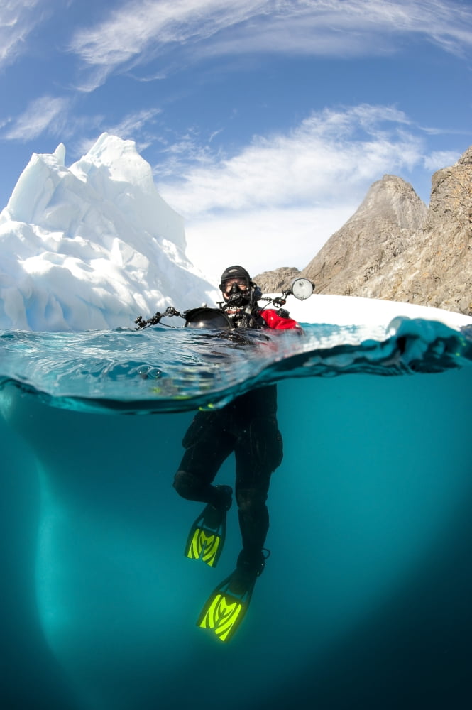 Diver in front of an iceberg Astrolabe Island Antarctic Peninsula Antarctica Canvas Art - Steve JonesStocktrek Images (12 x 18)