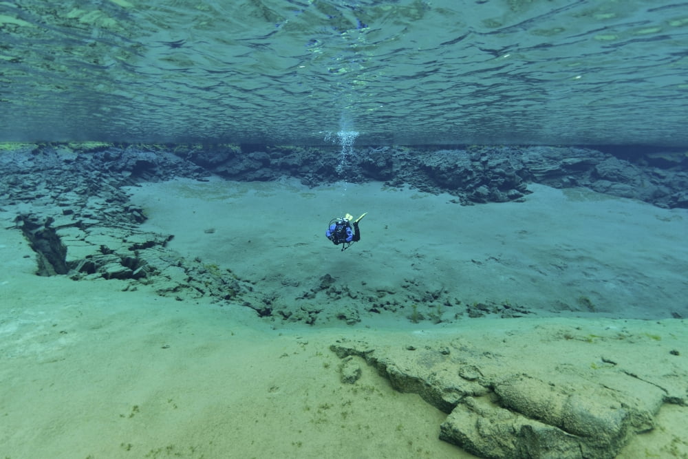Diver in ultra clear water at The Silfra Lagoon Iceland Canvas Art - Mathieu MeurStocktrek Images (18 x 12)