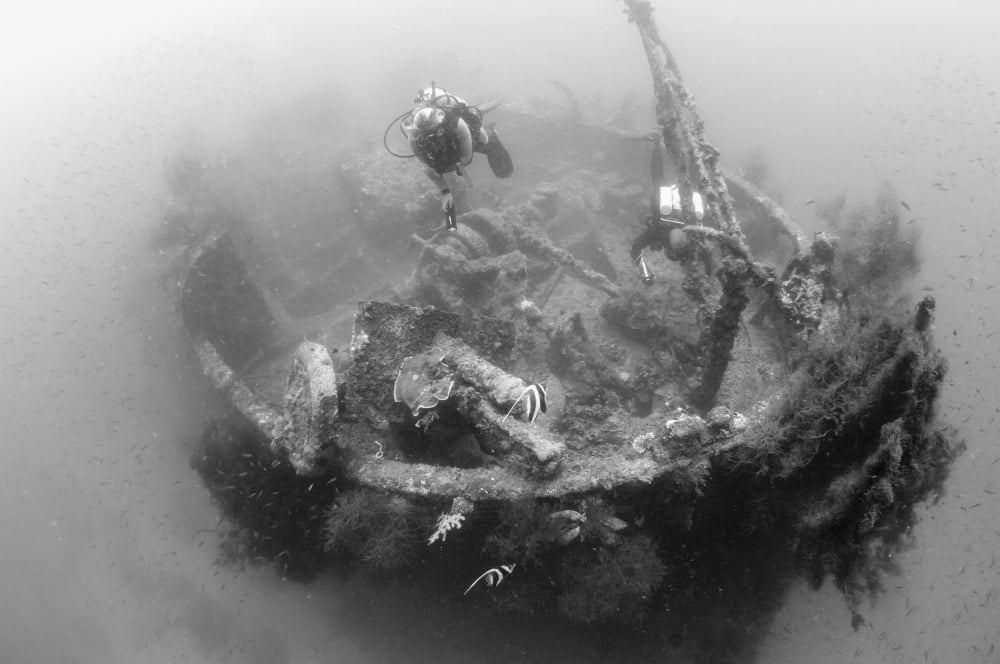 Divers explore the wreck of a Japanese Maru warship Solomon Islands Canvas Art - Steve JonesStocktrek Images (35 x 23)