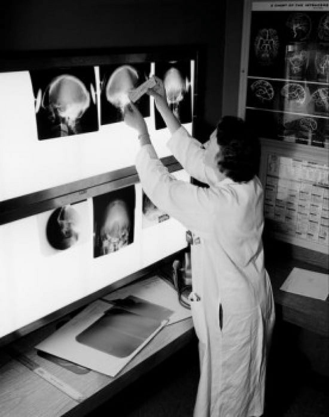 Doctor looking at x-rays Canvas Art - (18 x 24)