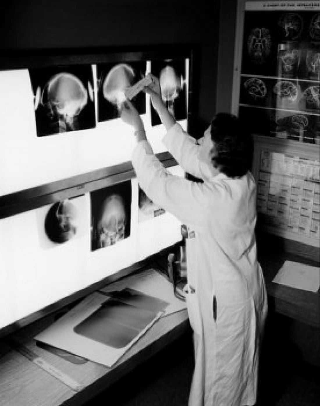 Doctor looking at x-rays Canvas Art - (24 x 36)