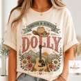 thumbnail image 1 of Dolly 1946 2026 Be Like Dolly Memorial T-Shirt, 1 of 5