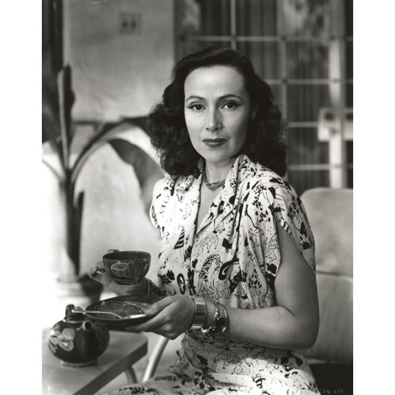 Dolores Del Rio sitting and Drinking Tea in Printed Dress Photo Print (8 x 10)