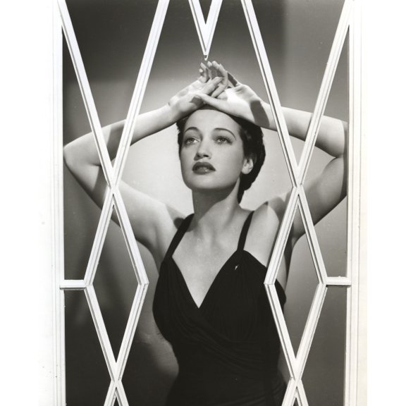Dorothy Lamour wearing a bathing suit behind a screen Photo Print (8 x 10)