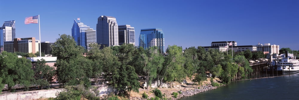 Downtown buildings at the waterfront Sacramento River Sacramento California USA Canvas Art - Panoramic Images (27 x 9)