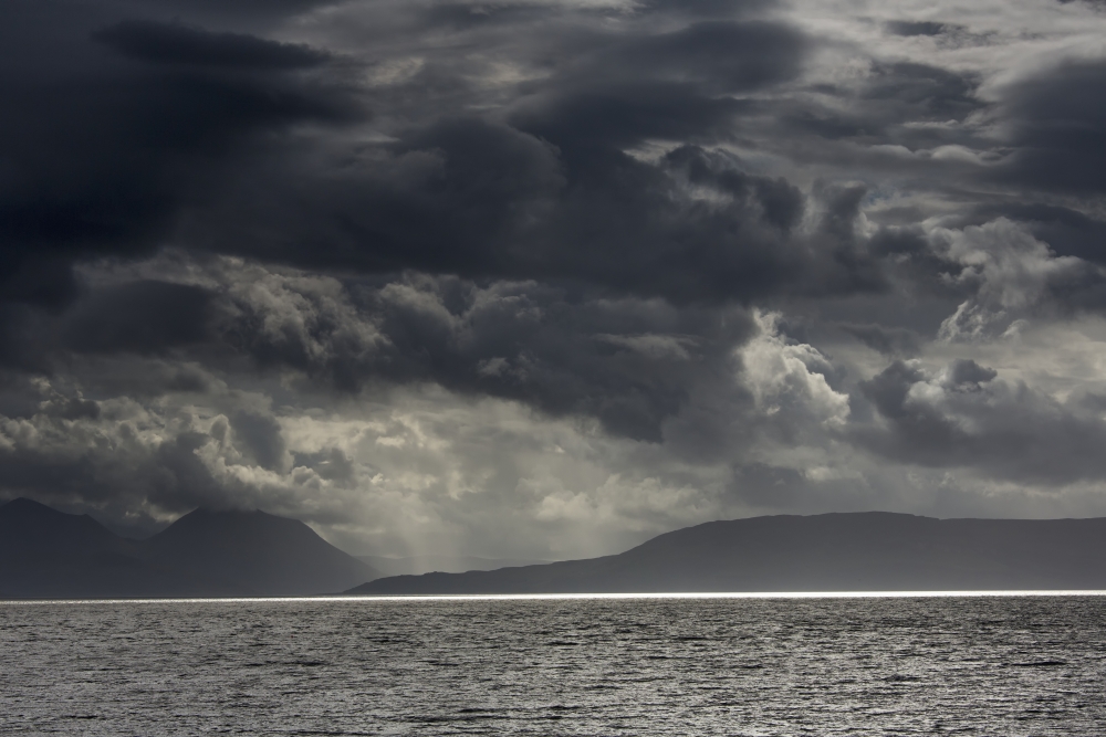 Dramatic sky with dark storm clouds over the ocean and a view of a silhouette of the coastlineApplecross peninsula scotland Canvas Art - John Short Design Pics (38 x 24)