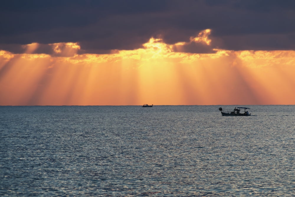 Dramatic sky with sun rays filtering down out of the storm clouds over the horizon Paphos Cyprus Canvas Art - John Short Design Pics (38 x 24)