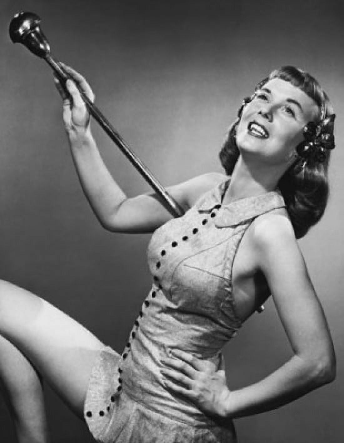 Drum majorette holding a twirling baton and smiling Canvas Art - (18 x 24)