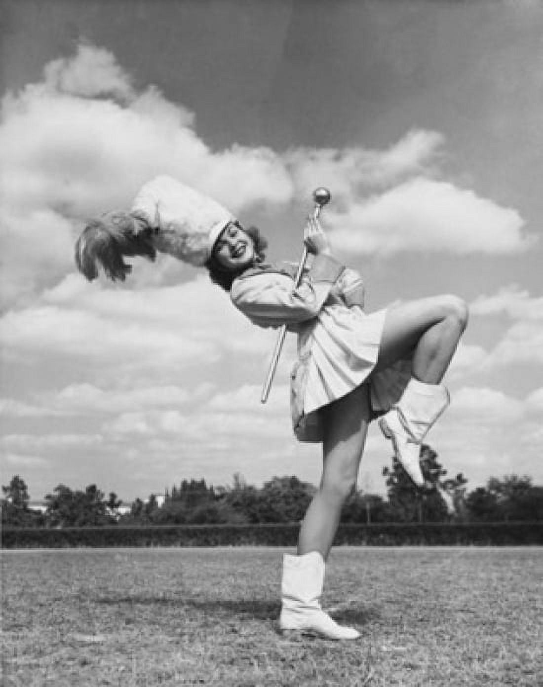Drum majorette performing with a twirling baton in a field Canvas Art - (18 x 24)