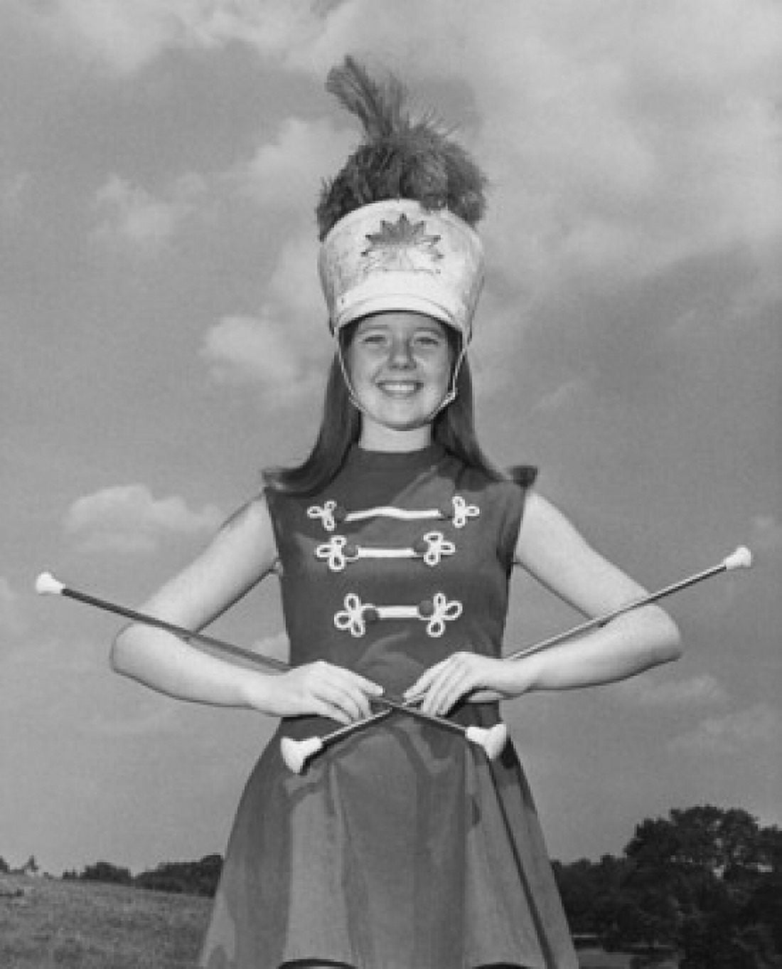Drum majorette performing with two twirling batons and smiling Canvas Art - (24 x 36)
