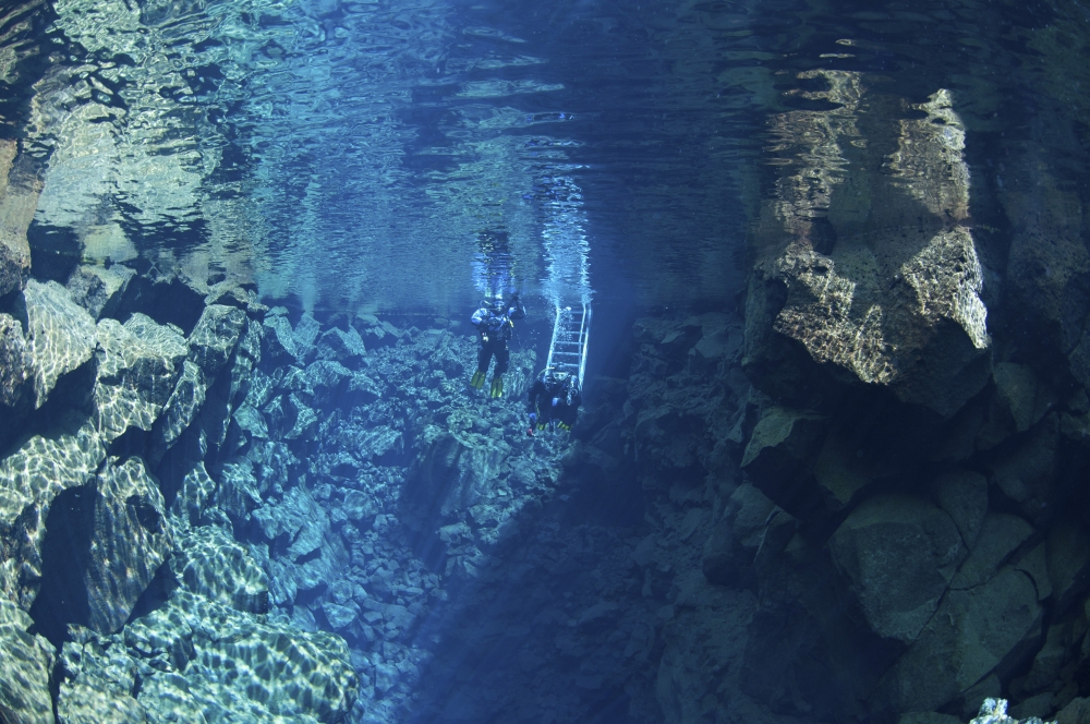Dry suit divers entering the gin clear water of Silfra Crack Iceland Canvas Art - Mathieu MeurStocktrek Images (18 x 12)