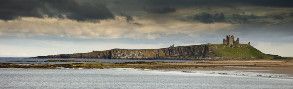 Dunstanburgh Castle On A Hill Under A Cloudy Sky Bamburgh Northumberland England Canvas Art - John Short Design Pics (44 x 13)
