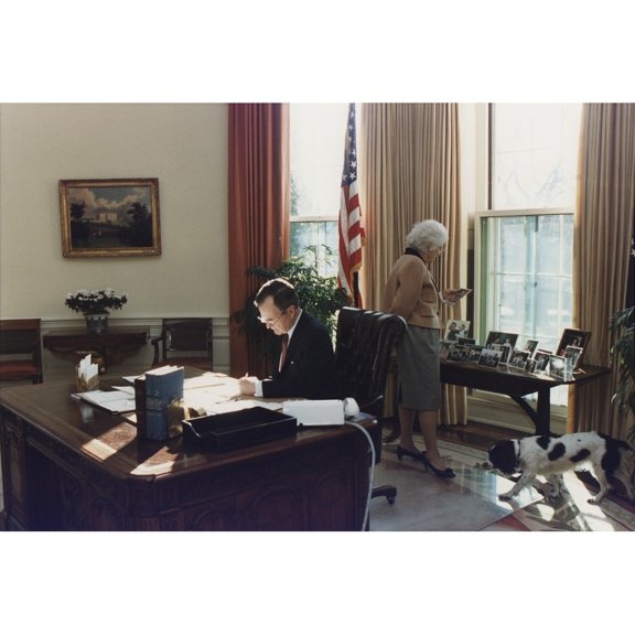 During His First Week As President George Bush Works In The Oval Office As Wife Barbara Looks At Photographs Behind The