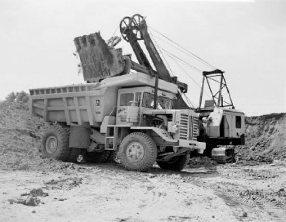 Earth mover putting soil on dump truck Canvas Art - (24 x 36)