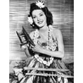 thumbnail image 1 of Eleanor Parker Wearing An Outfit Sent To Her By Her Husband Navy Lieutenant Fred Losee Who Is Stationed In The South Pacific December 1943 Photo Print (16 x 20), 1 of 2