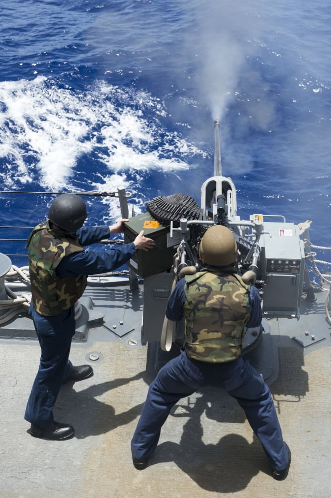Electronics Technician fires a 25mm machine gun aboard USS Preble Canvas Art - Stocktrek Images (23 x 35)