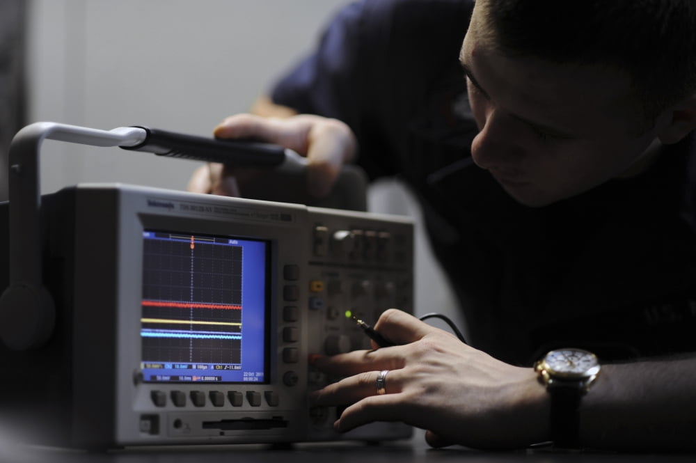 Electronics Technician troubleshoots an oscilloscope Canvas Art - Stocktrek Images (34 x 23)