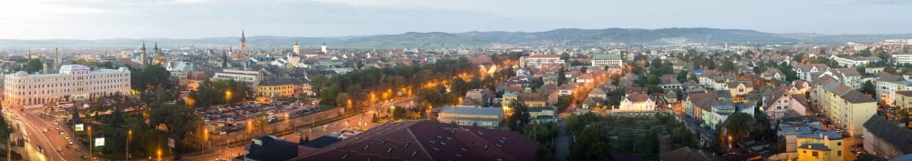 Elevated view of a city lit up at dusk Sibiu Transylvania Romania Canvas Art - Panoramic Images (44 x 8)