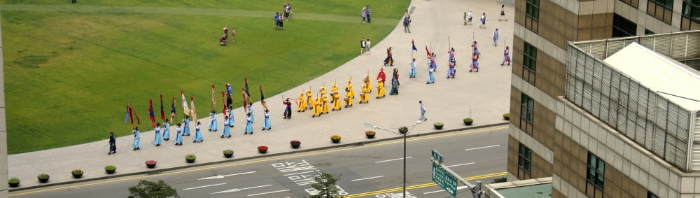 Elevated view of a procession in traditional garb at Seoul Plaza Seoul City Hall Seoul South Korea Canvas Art - Panoramic Images (27 x 9)