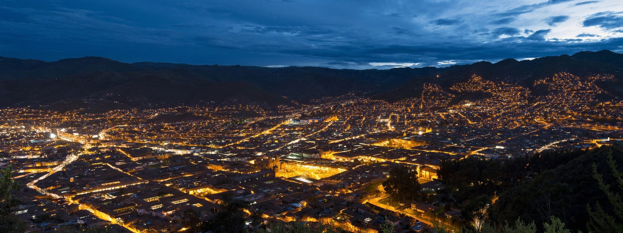 Elevated view of illuminated cityscape from Saksaywaman Cusco Urubamba Province Cusco Region Peru Canvas Art - Panoramic Images (27 x 9)