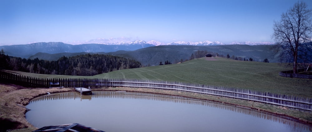 Elevated view of pond with mountain range in the background Renon Dolomites South Tyrol Italy Canvas Art - Panoramic Images (27 x 9)